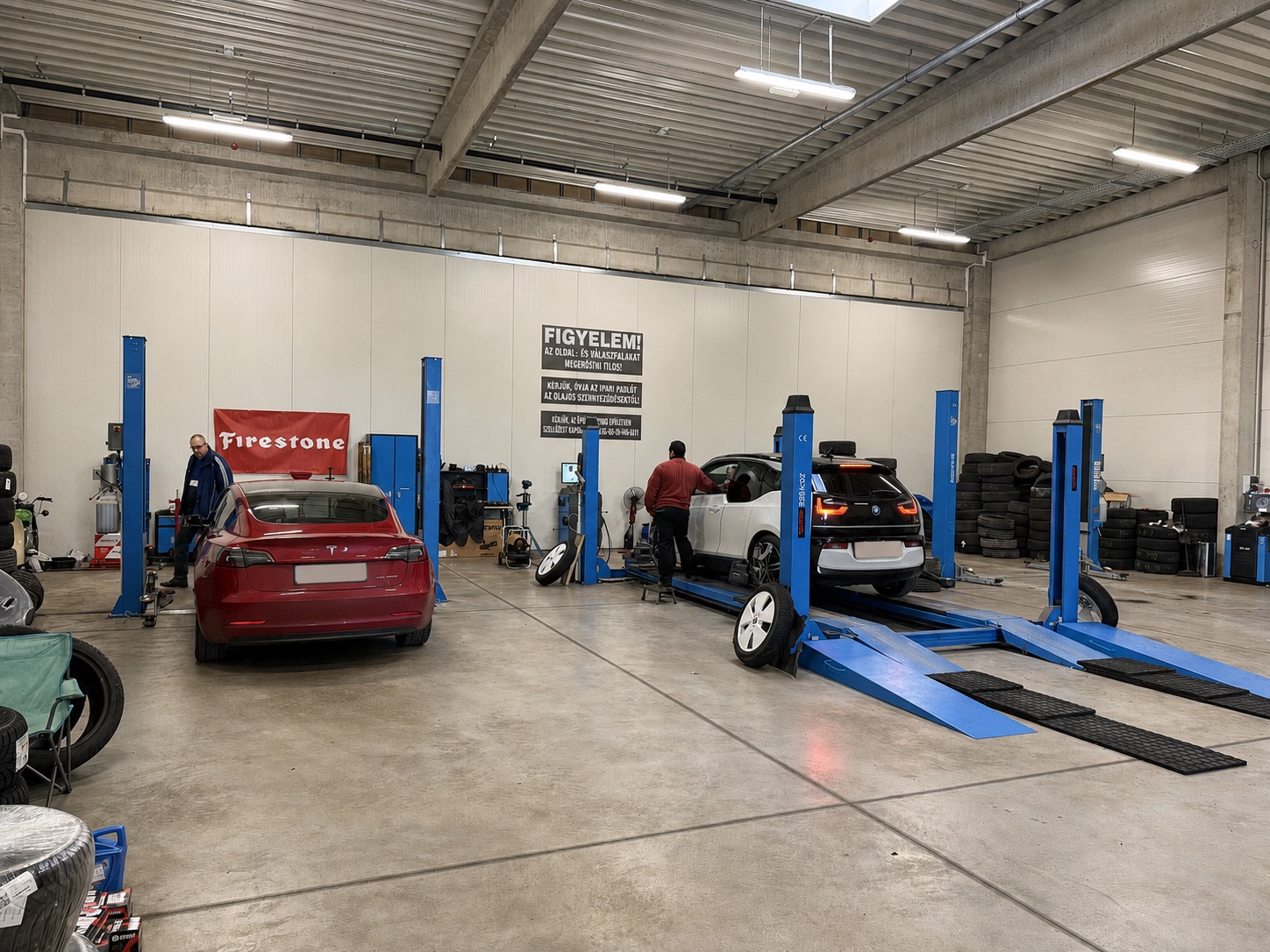 Cars, vehicle lifts and tyres inside the working ProAuto workshop